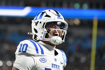 Dec 6, 2025; Charlotte, NC, USA; Duke Blue Devils quarterback Darian Mensah (10) celebrates after the Blue Devils score a touchdown in overtime during the  ACC Championship game at Bank of America Stadium. Mandatory Credit: Bob Donnan-Imagn Images