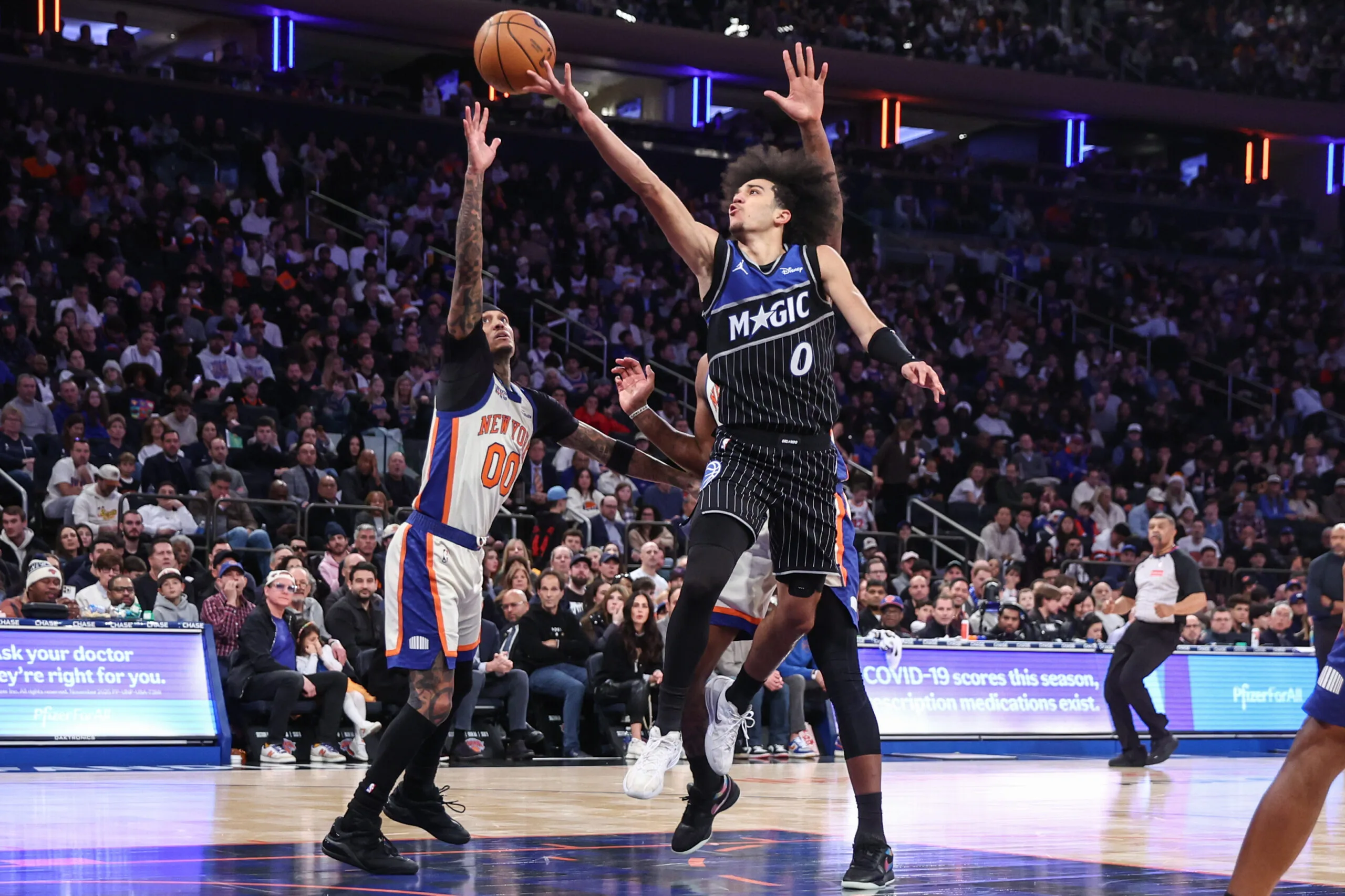 Dec 7, 2025; New York, New York, USA;  Orlando Magic guard Anthony Black (0) drives past New York Knicks guard Jordan Clarkson (00) in the fourth quarter at Madison Square Garden. Mandatory Credit: Wendell Cruz-Imagn Images