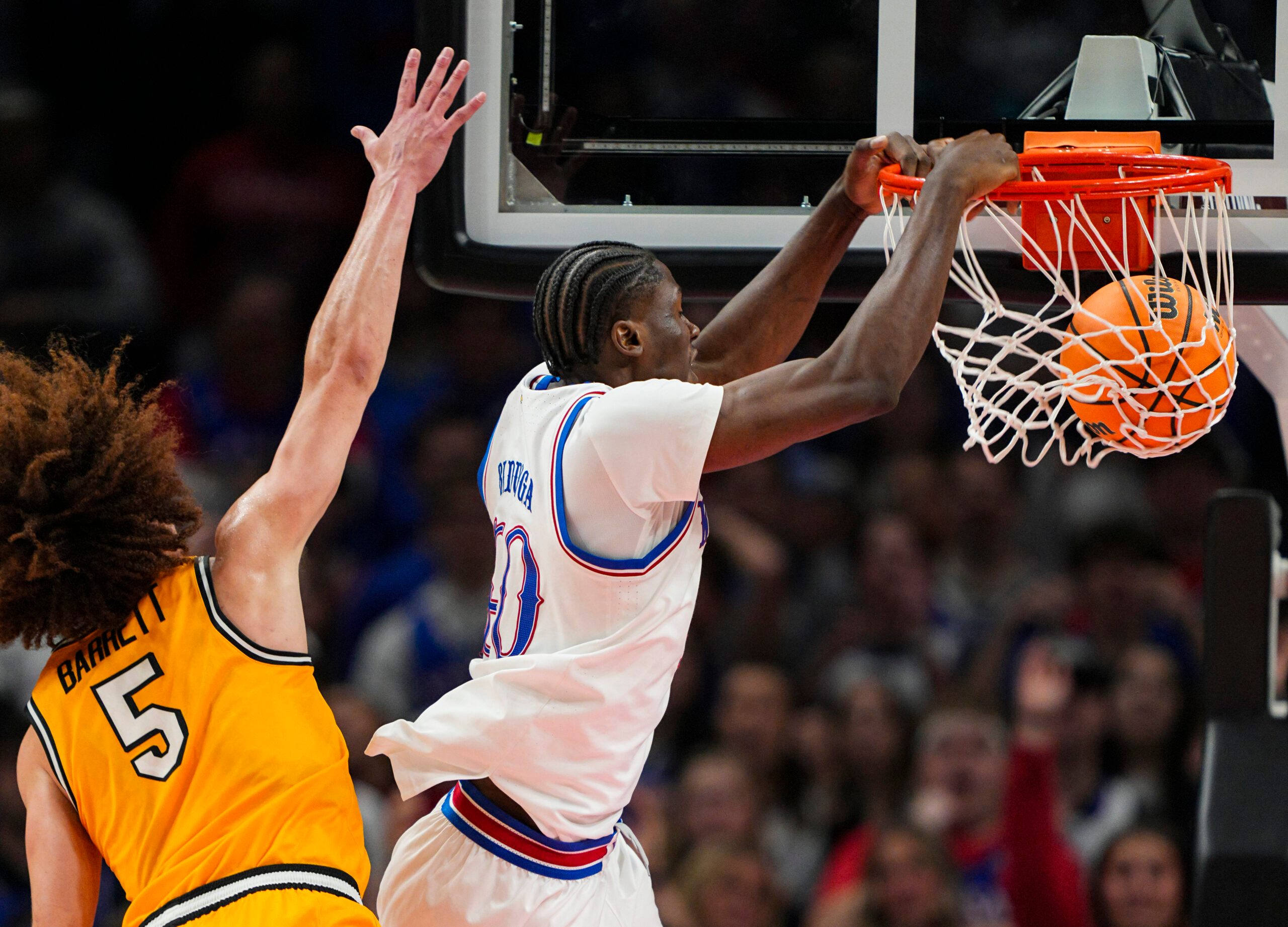 Dec 7, 2025; Kansas City, Missouri, USA; Kansas Jayhawks forward Flory Bidunga (40) dunks the ball against Missouri Tigers guard T.O. Barrett (5) during the second half at T-Mobile Center. Mandatory Credit: Jay Biggerstaff-Imagn Images