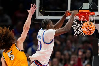 Dec 7, 2025; Kansas City, Missouri, USA; Kansas Jayhawks forward Flory Bidunga (40) dunks the ball against Missouri Tigers guard T.O. Barrett (5) during the second half at T-Mobile Center. Mandatory Credit: Jay Biggerstaff-Imagn Images