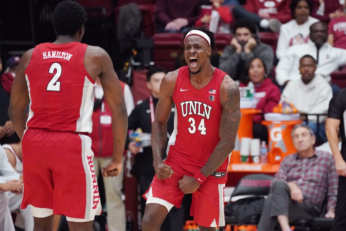 Dec 7, 2025; Stanford, California, USA; UNLV Runnin' Rebels center Emmanuel Stephen (34) celebrates with UNLV Runnin' Rebels forward Kimani Hamilton (2) after a basket at the buzzer at the end of the first half at Maples Pavilion. Mandatory Credit: David Gonzales-Imagn Images