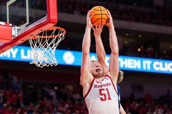 Dec 7, 2025; Lincoln, Nebraska, USA; Nebraska Cornhuskers forward Rienk Mast (51) comes down with a rebound against Creighton Bluejays guard Josh Dix (4) during the first half at Pinnacle Bank Arena. Mandatory Credit: Dylan Widger-Imagn Images