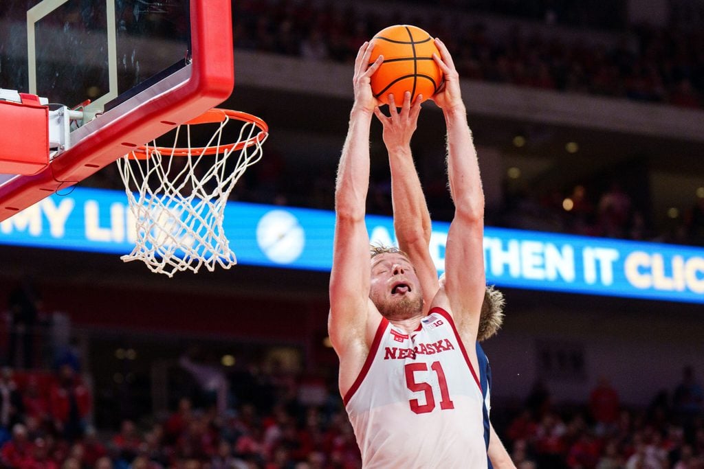 Dec 7, 2025; Lincoln, Nebraska, USA; Nebraska Cornhuskers forward Rienk Mast (51) comes down with a rebound against Creighton Bluejays guard Josh Dix (4) during the first half at Pinnacle Bank Arena. Mandatory Credit: Dylan Widger-Imagn Images