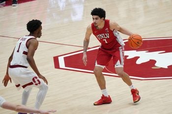 Dec 7, 2025; Stanford, California, USA;  UNLV Runnin' Rebels guard Al Green (7) dribbles upcourt against Stanford Cardinal guard Ebuka Okorie (1) in the second half at Maples Pavilion. Mandatory Credit: David Gonzales-Imagn Images
