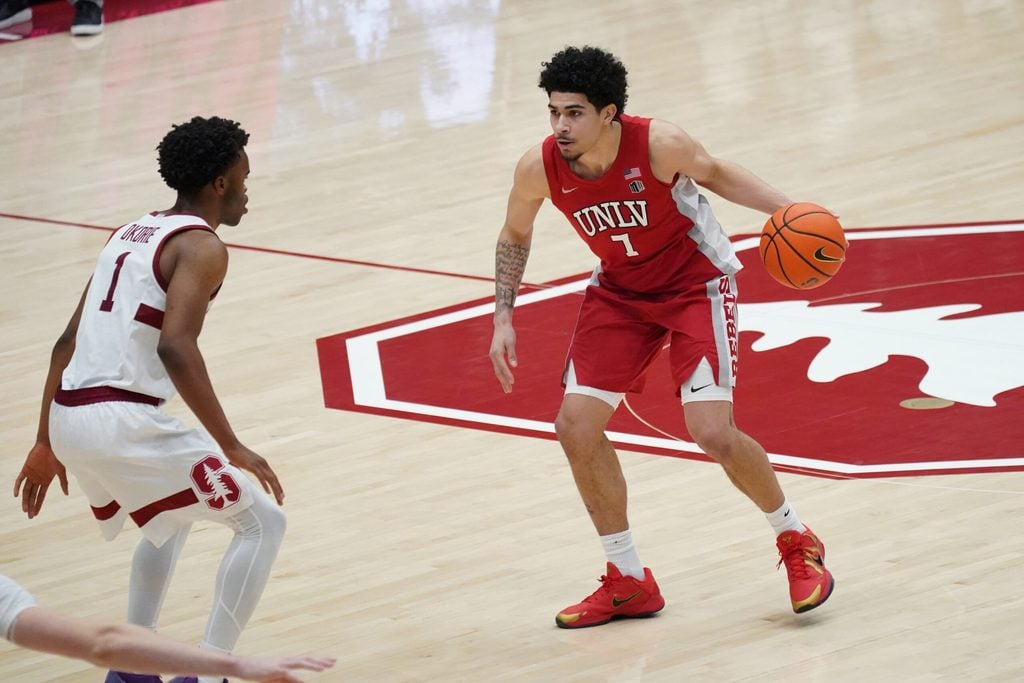 Dec 7, 2025; Stanford, California, USA; UNLV Runnin' Rebels guard Al Green (7) dribbles upcourt against Stanford Cardinal guard Ebuka Okorie (1) in the second half at Maples Pavilion. Mandatory Credit: David Gonzales-Imagn Images