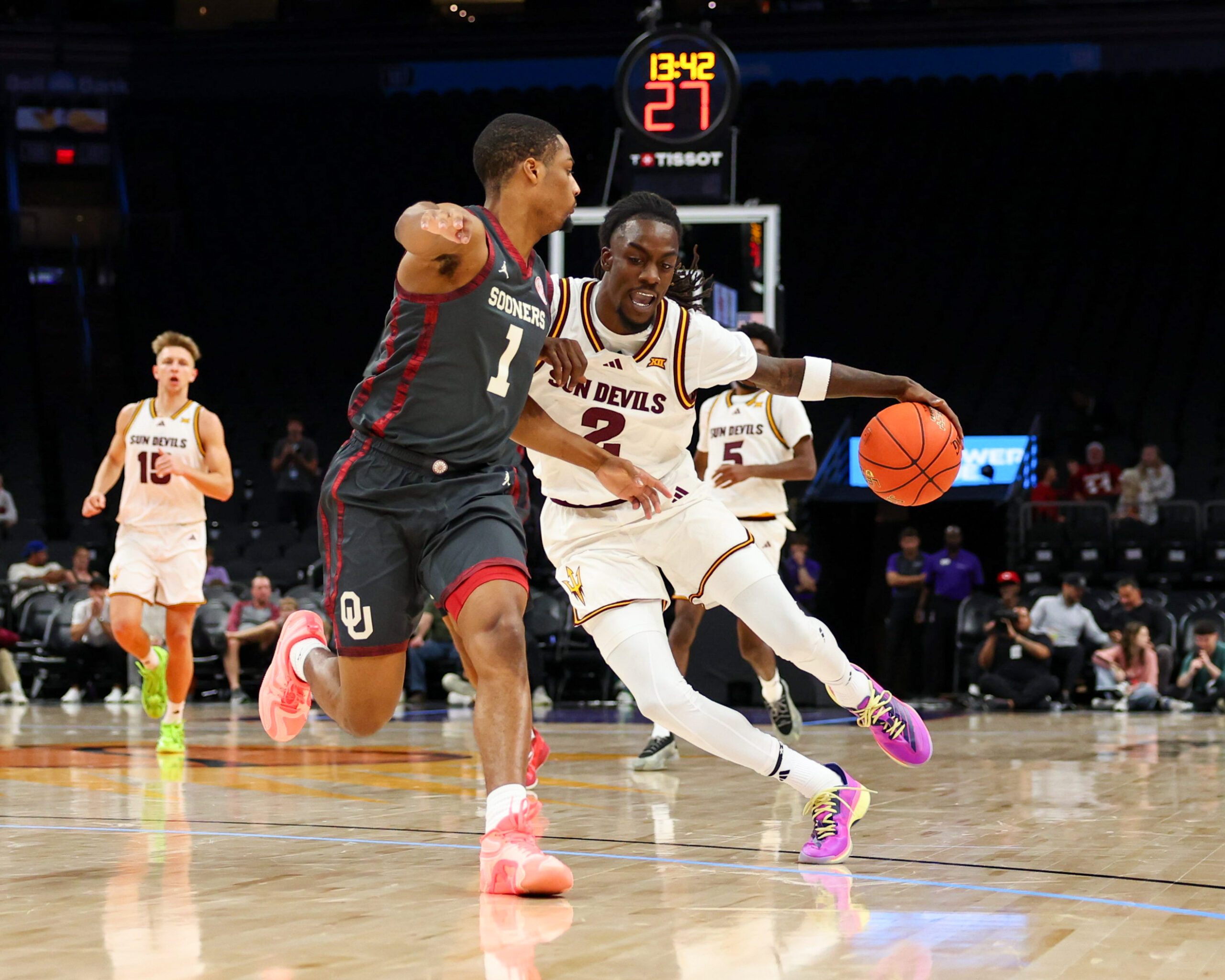 Dec 6, 2025; Phoenix, Arizona, USA; Arizona State University Sun Devils guard Anthony Johnson (2) dribbles against Oklahoma University Sooners guard Xzayvier Brown (1) in the second half at PHX Arena. Mandatory Credit: Anna Carrington-Imagn Images
