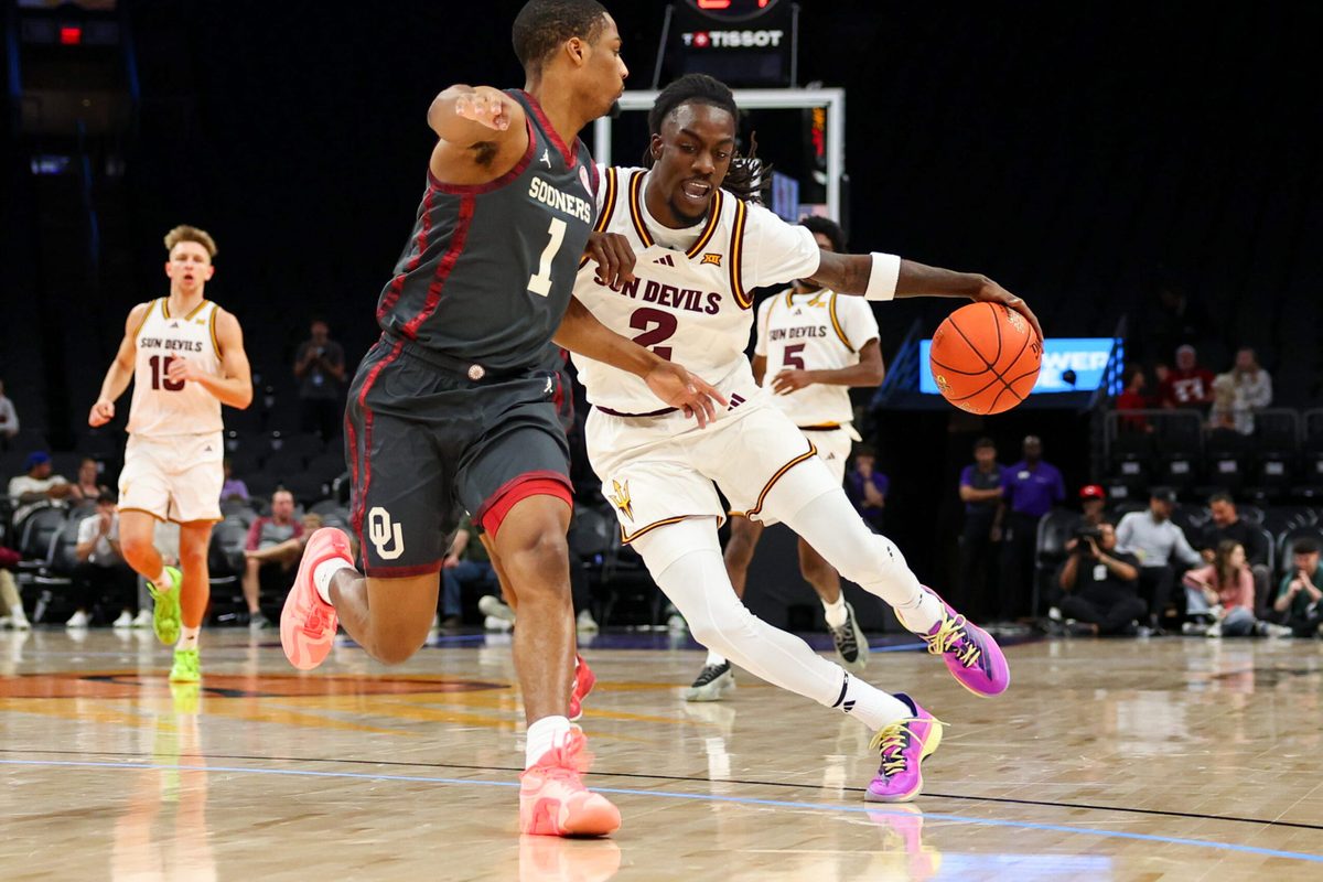 Dec 6, 2025; Phoenix, Arizona, USA; Arizona State University Sun Devils guard Anthony Johnson (2) dribbles against Oklahoma University Sooners guard Xzayvier Brown (1) in the second half at PHX Arena. Mandatory Credit: Anna Carrington-Imagn Images