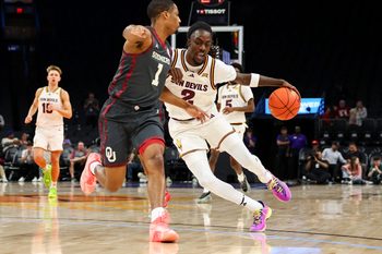 Dec 6, 2025; Phoenix, Arizona, USA; Arizona State University Sun Devils guard Anthony Johnson (2) dribbles against Oklahoma University Sooners guard Xzayvier Brown (1) in the second half at PHX Arena. Mandatory Credit: Anna Carrington-Imagn Images