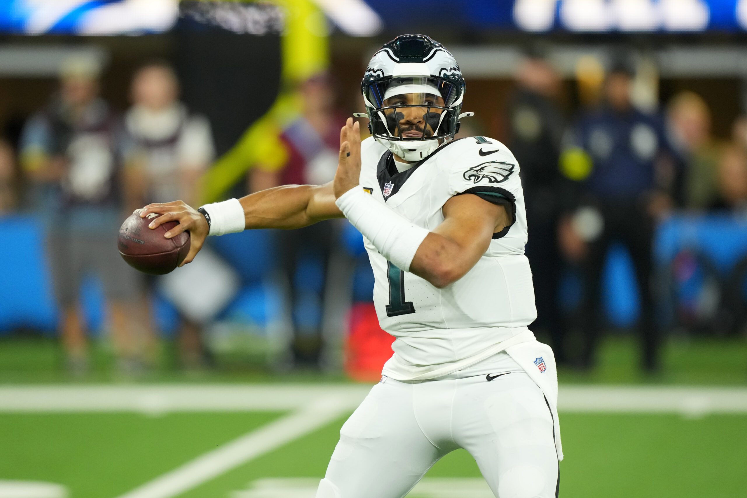 Dec 8, 2025; Inglewood, California, USA;  Philadelphia Eagles quarterback Jalen Hurts (1) passes against the Los Angeles Chargers in the first half at SoFi Stadium. Mandatory Credit: Kirby Lee-Imagn Images