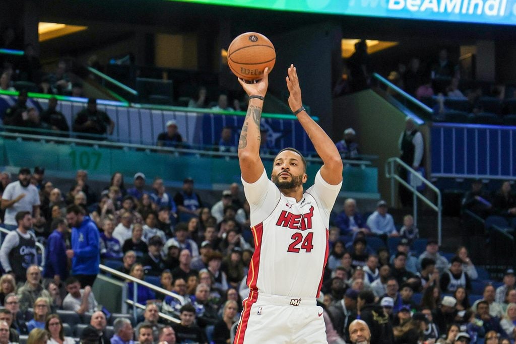 Dec 9, 2025; Orlando, Florida, USA; Miami Heat guard Norman Powell (24) shoots a three point basket during the second quarter against the Orlando Magic at Kia Center. Mandatory Credit: Mike Watters-Imagn Images