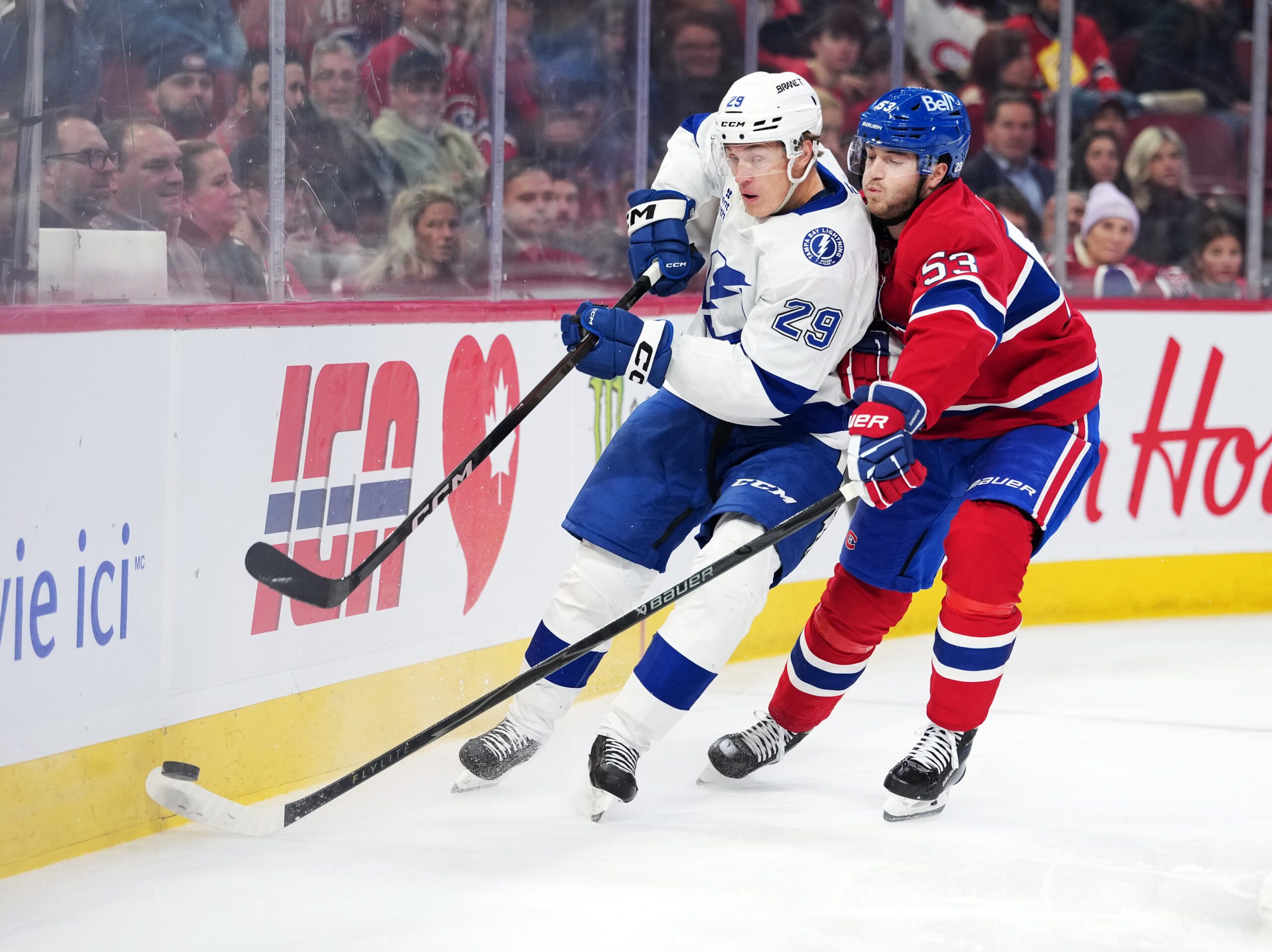 Dec 9, 2025; Montreal, Quebec, CAN; Tampa Bay Lightning forward Pontus Holmberg (29) plays the puck and Montreal Canadiens defenseman Noah Dobson (53) defends during the first period at the Bell Centre. Mandatory Credit: Eric Bolte-Imagn Images