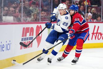 Dec 9, 2025; Montreal, Quebec, CAN; Tampa Bay Lightning forward Pontus Holmberg (29) plays the puck and Montreal Canadiens defenseman Noah Dobson (53) defends during the first period at the Bell Centre. Mandatory Credit: Eric Bolte-Imagn Images