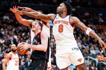 Dec 9, 2025; Toronto, Ontario, CAN;  Toronto Raptors center Jakob Poeltl (19) drives to the basket against New York Knicks forward Og Anunoby (8) during the second half at the 2025-26 NBA Emirates Cup at Scotiabank Arena. Mandatory Credit: Kevin Sousa-Imagn Images