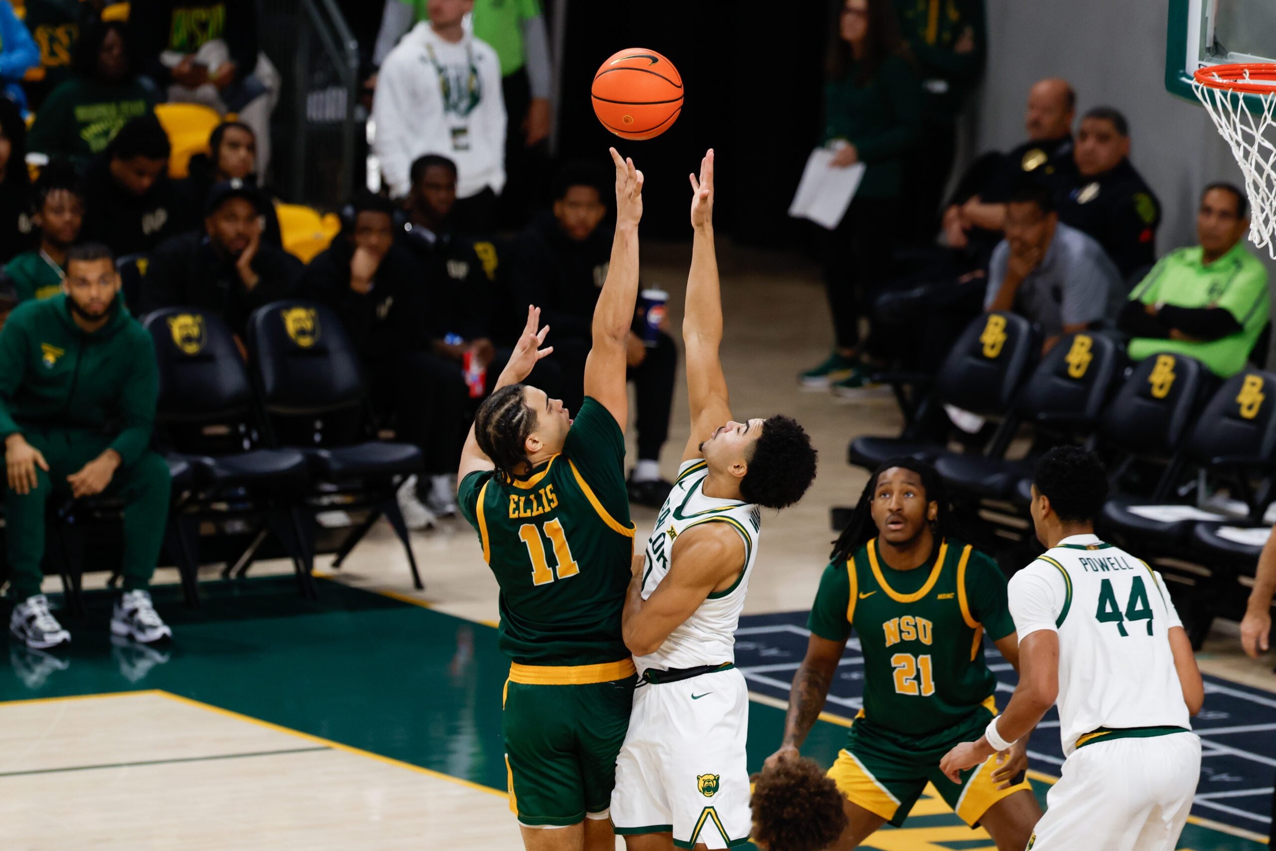 Dec 10, 2025; Waco, Texas, USA; Norfolk State Spartans forward Devon Ellis (11) scores a basket over Baylor Bears guard Isaac Williams (10) during the second half at Paul and Alejandra Foster Pavilion. Mandatory Credit: Chris Jones-Imagn Images