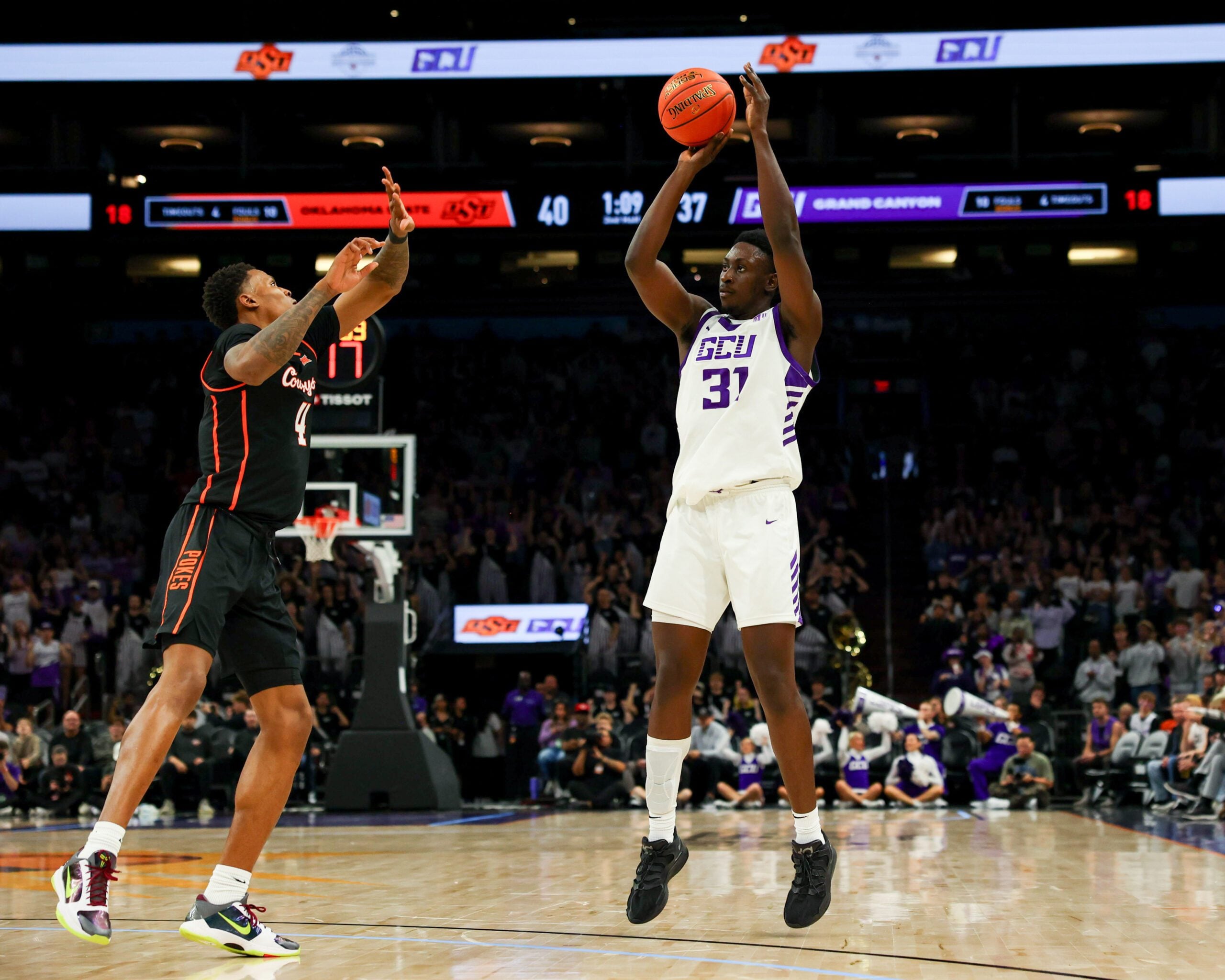 Dec 6, 2025; Phoenix, Arizona, USA; Grand Canyon University Antelopes forward Nana Owusu Anane (31) attempts a three-point shot against Oklahoma State University Cowboys guard Christian Coleman (4) in the first half at PHX Arena. Mandatory Credit: Anna Carrington-Imagn Images
