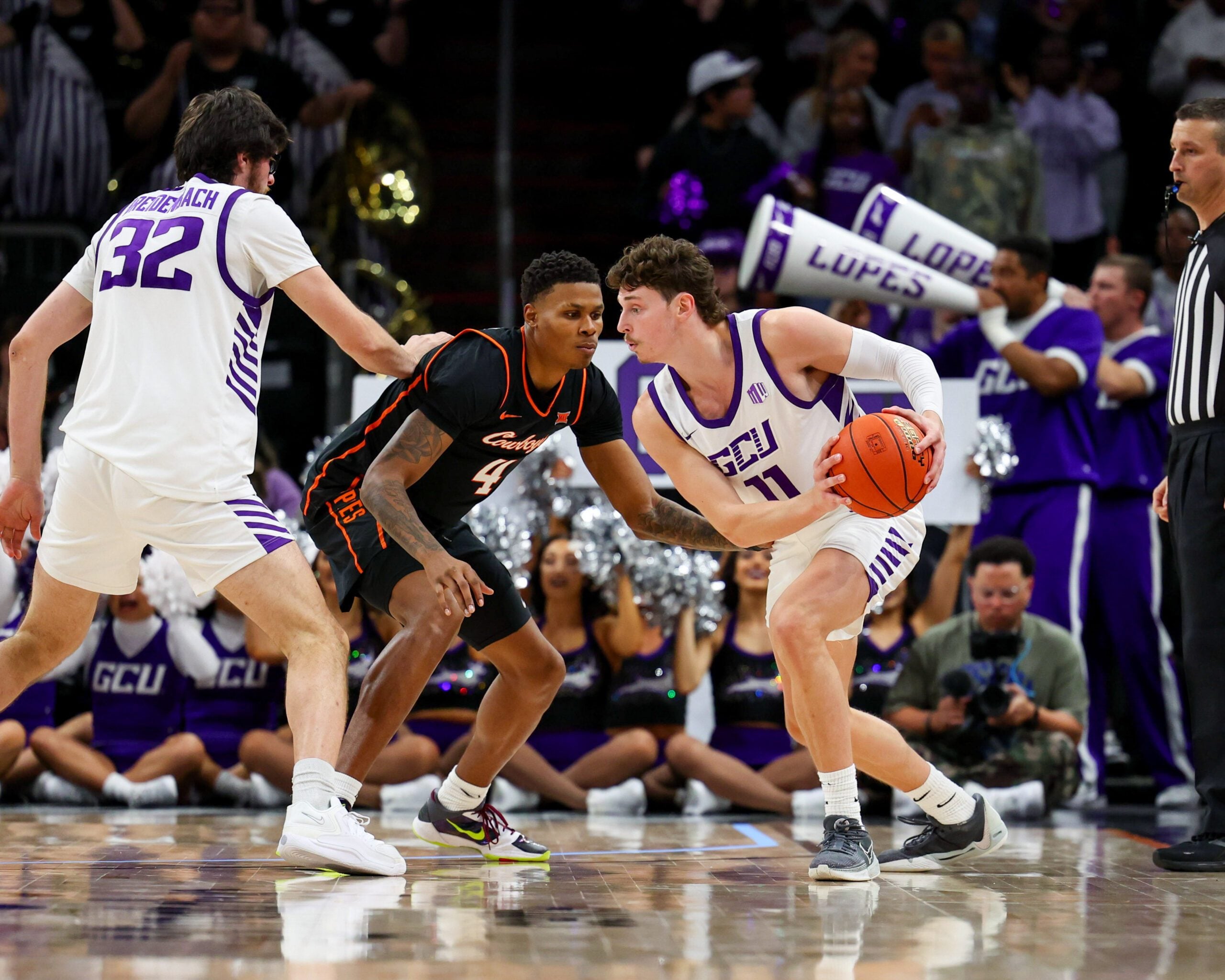 Dec 6, 2025; Phoenix, Arizona, USA; Grand Canyon University Antelopes guard Caleb Shaw (11) dribbles against Oklahoma State University Cowboys guard Christian Coleman (4) in the second half at PHX Arena. Mandatory Credit: Anna Carrington-Imagn Images