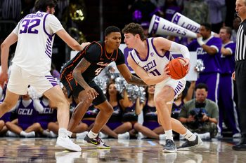 Dec 6, 2025; Phoenix, Arizona, USA; Grand Canyon University Antelopes guard Caleb Shaw (11) dribbles against Oklahoma State University Cowboys guard Christian Coleman (4) in the second half at PHX Arena. Mandatory Credit: Anna Carrington-Imagn Images