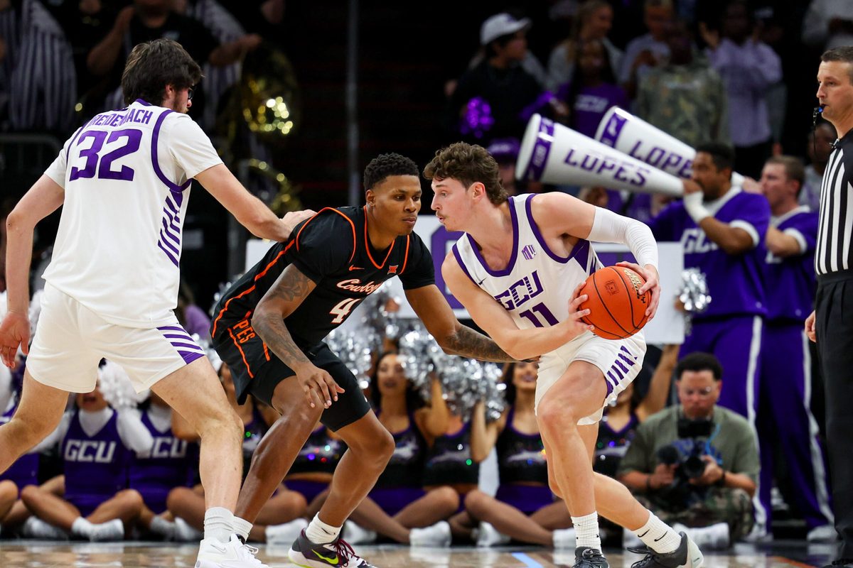 Dec 6, 2025; Phoenix, Arizona, USA; Grand Canyon University Antelopes guard Caleb Shaw (11) dribbles against Oklahoma State University Cowboys guard Christian Coleman (4) in the second half at PHX Arena. Mandatory Credit: Anna Carrington-Imagn Images
