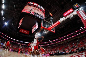 Dec 6, 2025; Raleigh, North Carolina, USA; NC State Wolfpack guard Quadir Copeland (11) dunks the ball past Liberty Flames guard JJ Harper (9) during the first half of the game at Lenovo Center. Mandatory Credit: Jaylynn Nash-Imagn Images