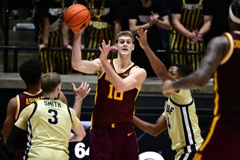 Dec 10, 2025; West Lafayette, Indiana, USA; Minnesota Golden Gophers forward Cade Tyson (10) passes the ball away from Purdue Boilermakers guard Gicarri Harris (24) during the second half at Mackey Arena. Mandatory Credit: Marc Lebryk-Imagn Images