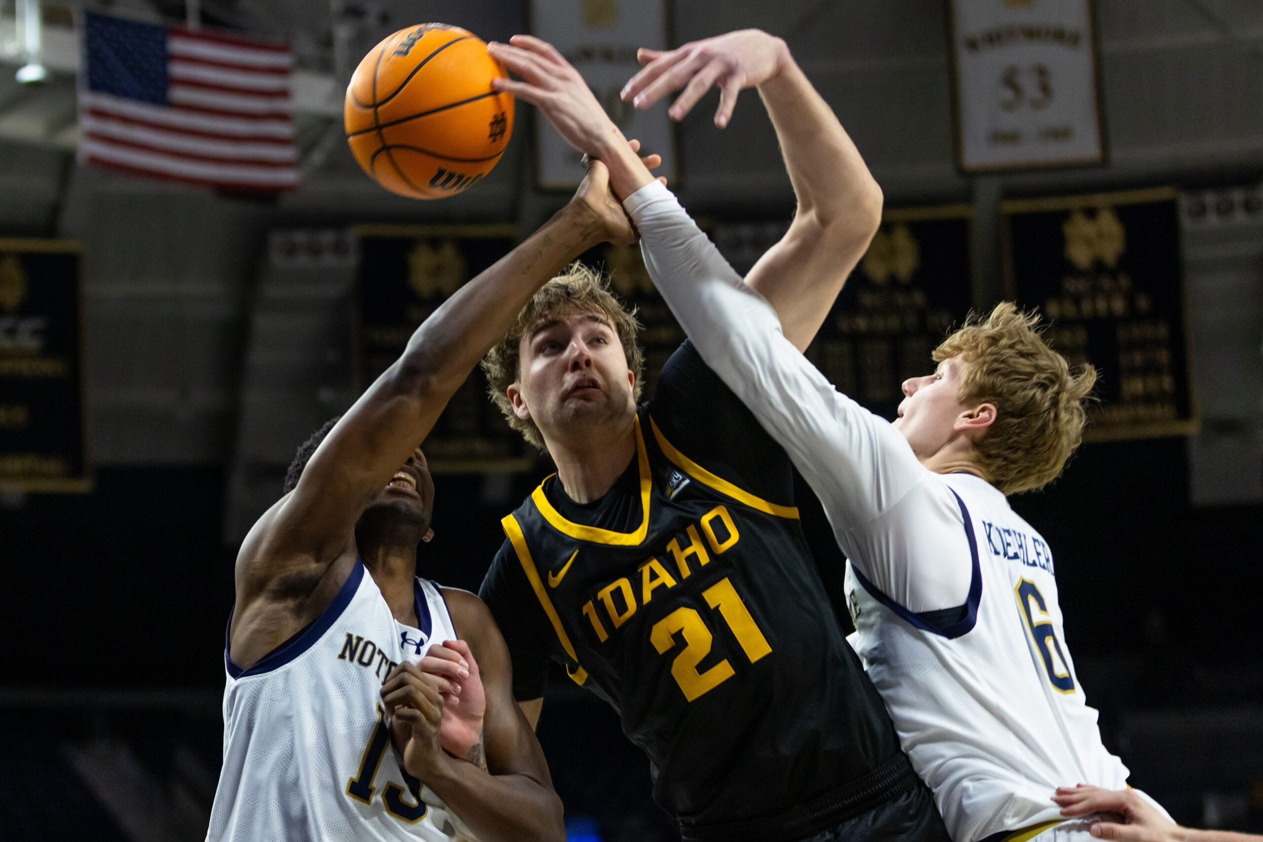 Dec 10, 2025; South Bend, Indiana, USA; Idaho Vandals forward Seth Joba (21) fights for a rebound with Notre Dame Fighting Irish guard Sir Mohammed (13) and forward Brady Koehler (6) during the second half at Purcell Pavilion at the Joyce Center. Mandatory Credit: Michael Caterina-Imagn Images