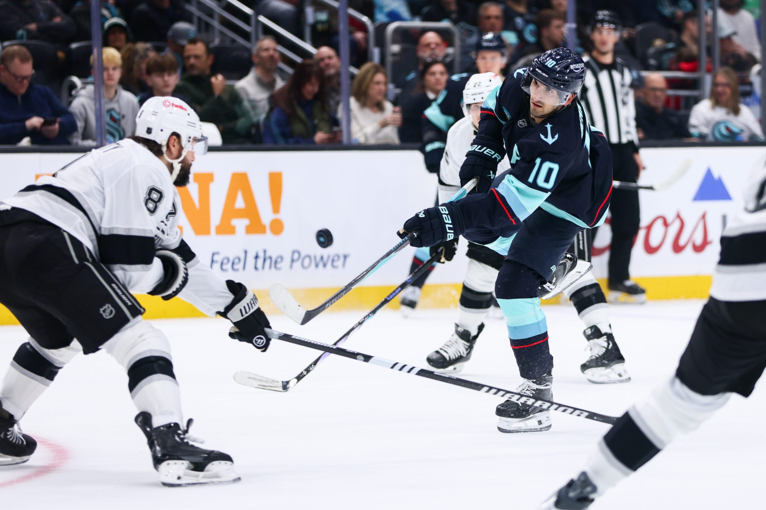 Dec 10, 2025; Seattle, Washington, USA; Seattle Kraken center Matty Beniers (10) attempts a shot on goal while defended by Los Angeles Kings defenseman Drew Doughty (8) in the first period at Climate Pledge Arena. Mandatory Credit: Kevin Ng-Imagn Images