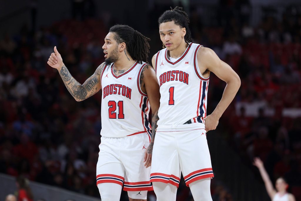 Dec 10, 2025; Houston, Texas, USA; Houston Cougars guard Isiah Harwell (1) looks on as guard Emanuel Sharp (21) gives a thumbs up during the second half against the Jackson State Tigers at Fertitta Center. Mandatory Credit: Troy Taormina-Imagn Images