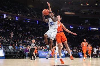 Dec 9, 2025; New York, New York, USA;  BYU Cougars guard Kennard Davis Jr. (30) and Clemson Tigers forward Nick Davidson (11) at Madison Square Garden. Mandatory Credit: Wendell Cruz-Imagn Images