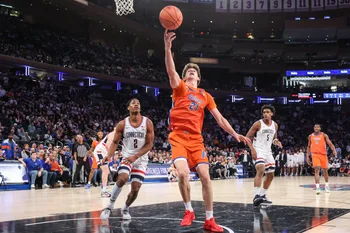 Dec 9, 2025; New York, New York, USA;  Florida Gators forward Alex Condon (21) and UConn Huskies guard Silas Demary Jr. (2) at Madison Square Garden. Mandatory Credit: Wendell Cruz-Imagn Images