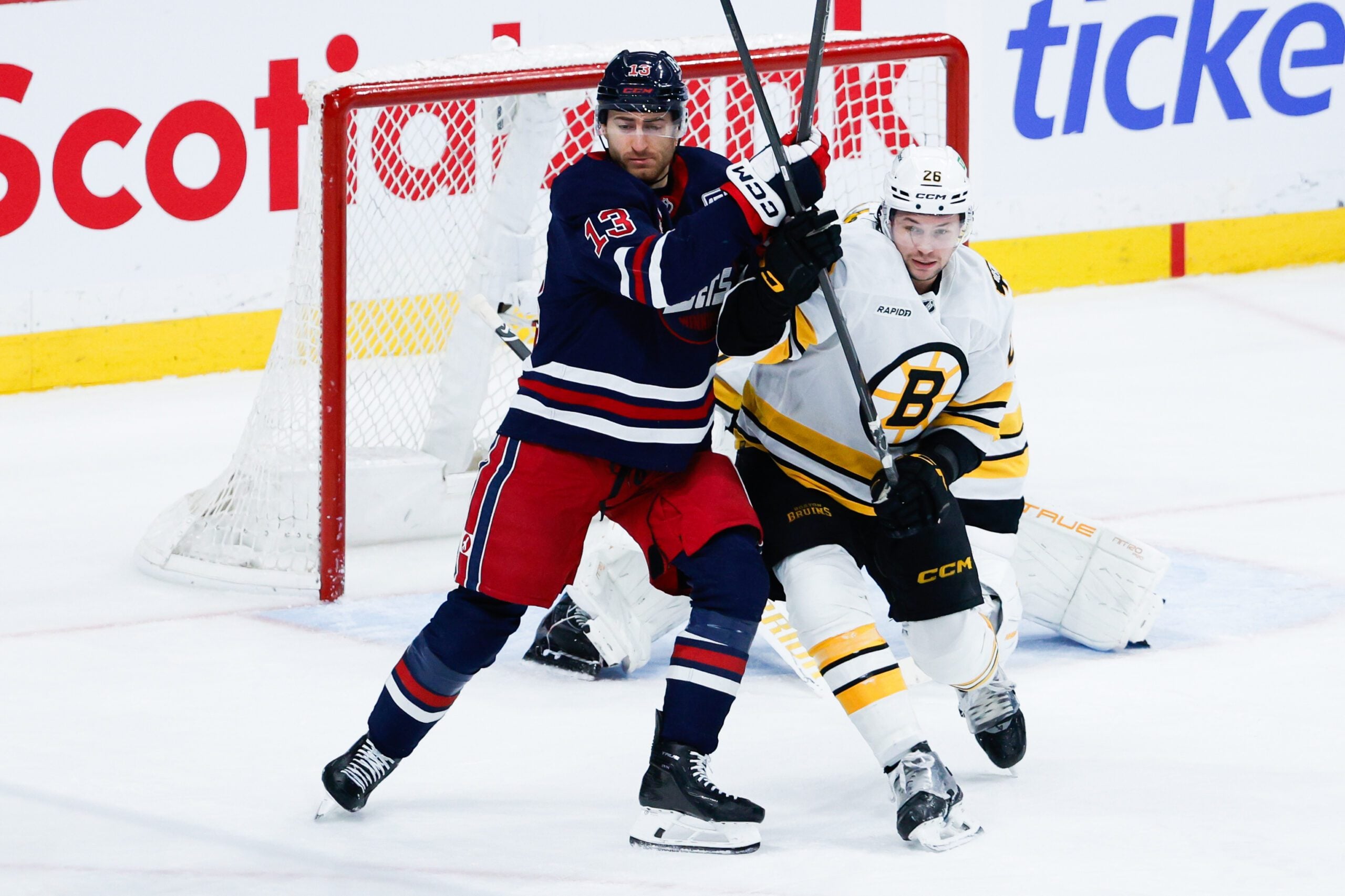 Dec 11, 2025; Winnipeg, Manitoba, CAN; Winnipeg Jets forward Gabriel Vilardi (13) jostles for position with Boston Bruins defensema Andrew Peeke (26) during the third period at Canada Life Centre.  Mandatory Credit: Terrence Lee-Imagn Images