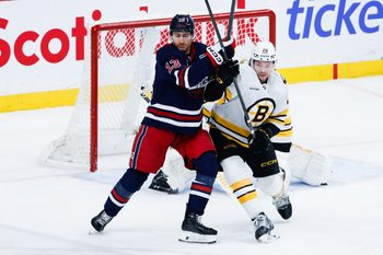 Dec 11, 2025; Winnipeg, Manitoba, CAN; Winnipeg Jets forward Gabriel Vilardi (13) jostles for position with Boston Bruins defensema Andrew Peeke (26) during the third period at Canada Life Centre.  Mandatory Credit: Terrence Lee-Imagn Images