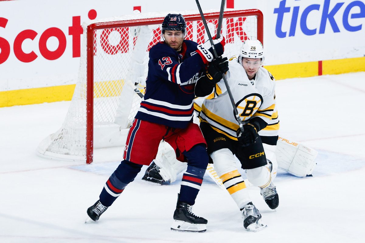 Dec 11, 2025; Winnipeg, Manitoba, CAN; Winnipeg Jets forward Gabriel Vilardi (13) jostles for position with Boston Bruins defensema Andrew Peeke (26) during the third period at Canada Life Centre. Mandatory Credit: Terrence Lee-Imagn Images