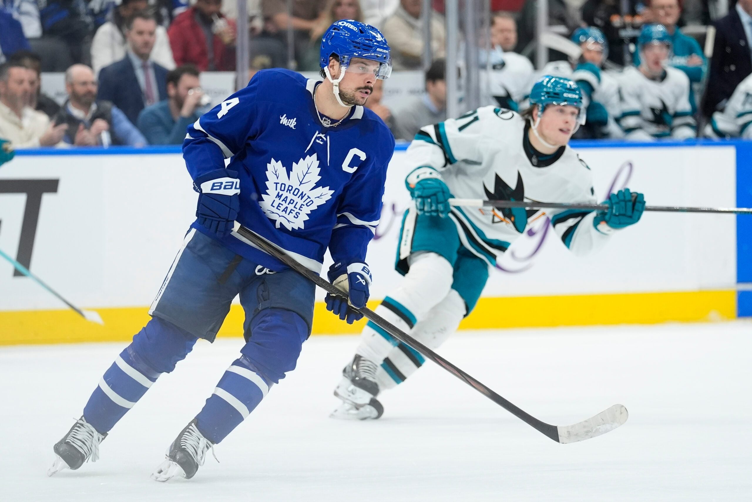 Dec 11, 2025; Toronto, Ontario, CAN; Toronto Maple Leafs forward Auston Matthews (34) and San Jose Sharks forward Macklin Celebrini (71) skate after the puck during the second period at Scotiabank Arena. Mandatory Credit: John E. Sokolowski-Imagn Images