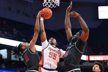 Dec 11, 2025; Syracuse, New York, USA; Saint Joseph's Hawks guard Jaiden Glover-Toscano (11) blocks the shot of Syracuse Orange guard Bryce Zephir (55) during the second half at the JMA Wireless Dome. Mandatory Credit: Rich Barnes-Imagn Images
