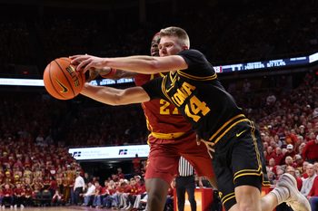 Dec 11, 2025; Ames, Iowa, USA; Iowa State Cyclones guard Killyan Toure (27) and Iowa Hawkeyes guard Bennett Stirtz (14) battle for a loose ball during the first half at James H. Hilton Coliseum. Mandatory Credit: Reese Strickland-Imagn Images