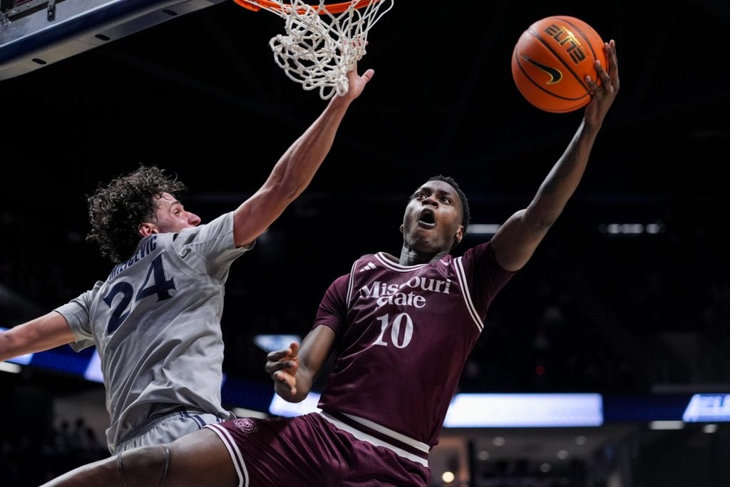 Dec 12, 2025; Cincinnati, Ohio, USA; Missouri State Bears forward Darrion Sutton (10) drives to the basket against Xavier Musketeers forward Jovan Milicevic (24) in the second half at the Cintas Center. Mandatory Credit: Aaron Doster-Imagn Images