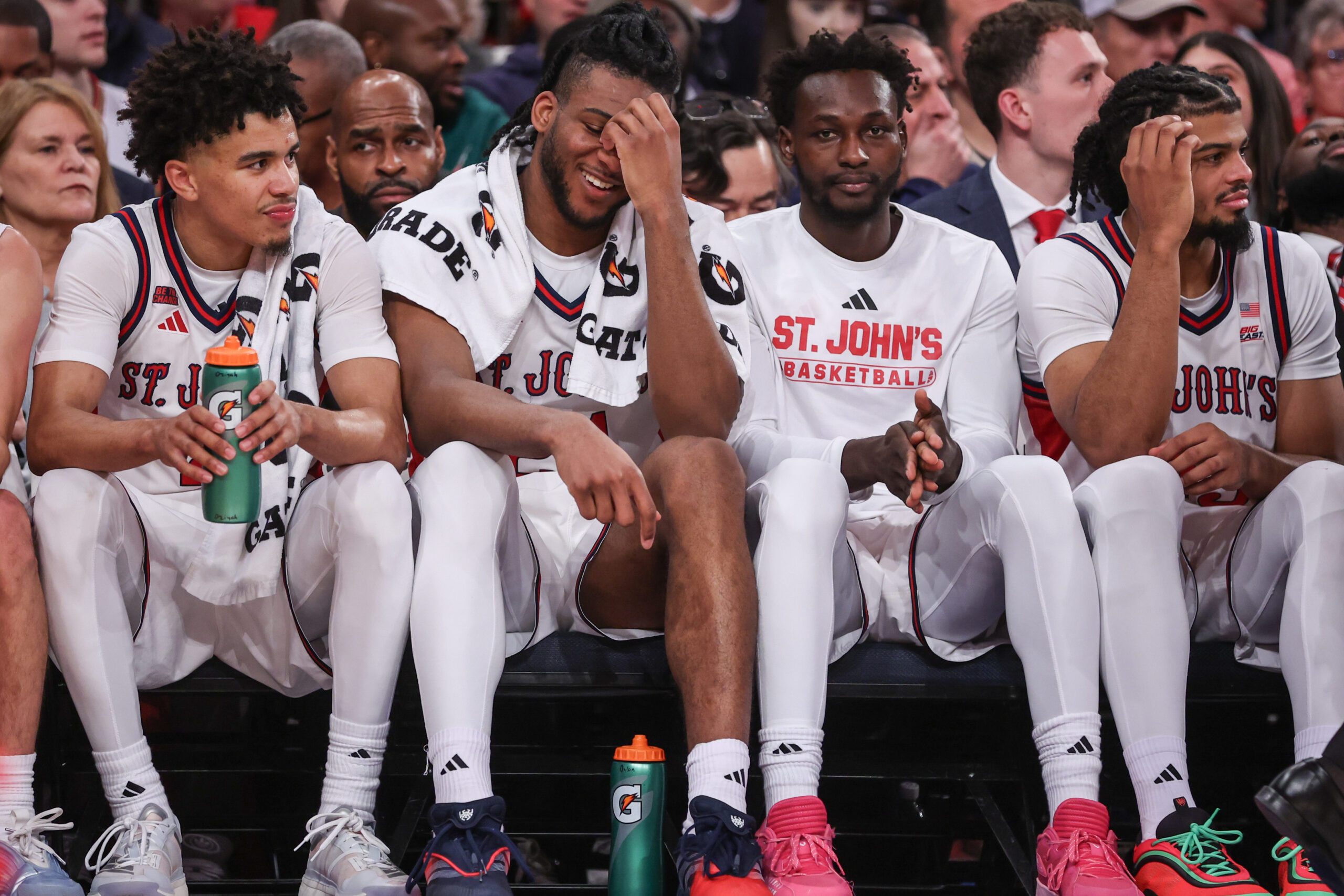 Dec 13, 2025; Queens, New York, USA; St. John's Red Storm guard Oziyah Sellers (4), forwards Zuby Ejiofor (24), Sadiku Ibine Ayo (2) and Bryce Hopkins (23) sit on the bench in the second half against the Iona Gaels at Madison Square Garden. Mandatory Credit: Wendell Cruz-Imagn Images