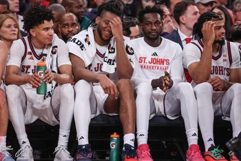Dec 13, 2025; Queens, New York, USA;  St. John's Red Storm guard Oziyah Sellers (4), forwards Zuby Ejiofor (24), Sadiku Ibine Ayo (2) and Bryce Hopkins (23) sit on the bench in the second half against the Iona Gaels at Madison Square Garden. Mandatory Credit: Wendell Cruz-Imagn Images