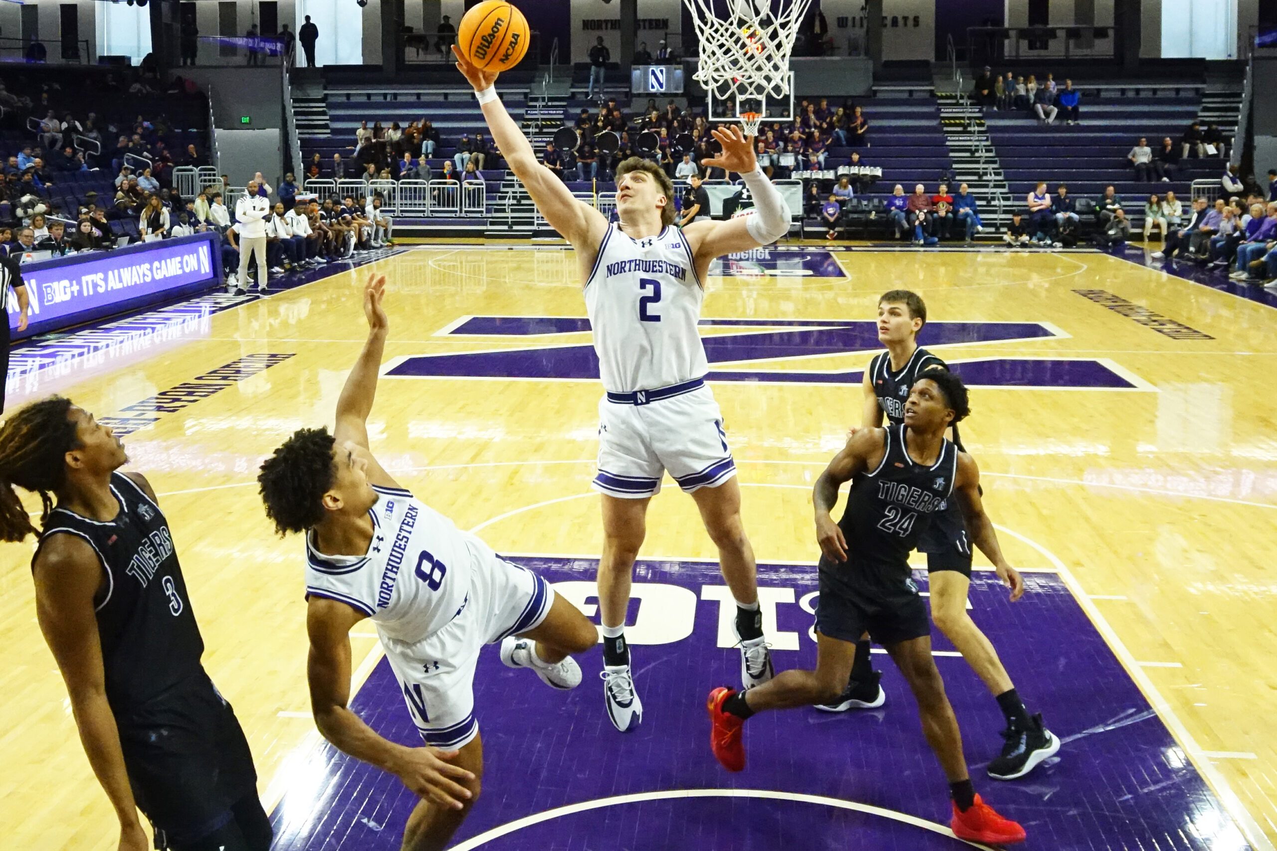 Dec 13, 2025; Evanston, Illinois, USA; Northwestern Wildcats forward Nick Martinelli (2) grabs a rebound in front of Jackson State Tigers guard Daeshun Ruffin (24) during the first half at Welsh-Ryan Arena. Mandatory Credit: David Banks-Imagn Images