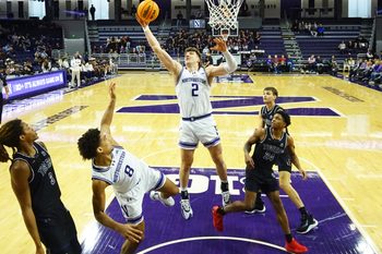 Dec 13, 2025; Evanston, Illinois, USA; Northwestern Wildcats forward Nick Martinelli (2) grabs a rebound in front of Jackson State Tigers guard Daeshun Ruffin (24) during the first half at Welsh-Ryan Arena. Mandatory Credit: David Banks-Imagn Images