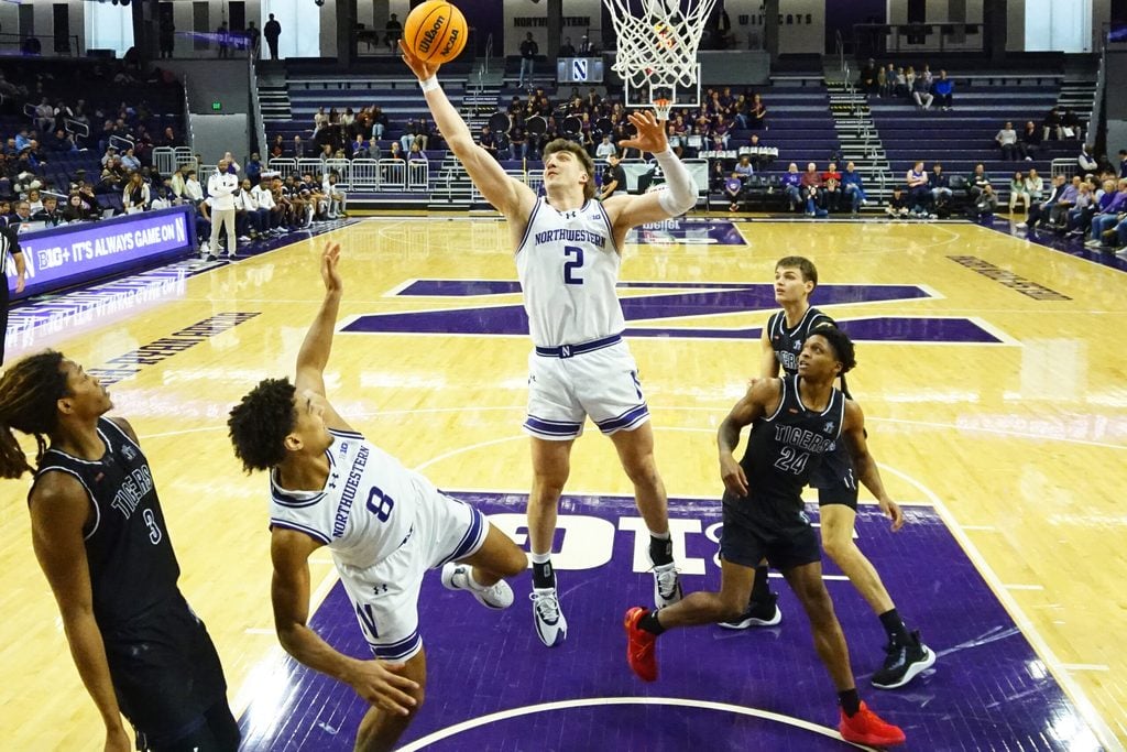 Dec 13, 2025; Evanston, Illinois, USA; Northwestern Wildcats forward Nick Martinelli (2) grabs a rebound in front of Jackson State Tigers guard Daeshun Ruffin (24) during the first half at Welsh-Ryan Arena. Mandatory Credit: David Banks-Imagn Images