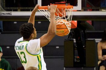Oregon forward Sean Stewart dunks the ball as the Oregon Ducks host the UC Davis Aggies on Dec. 13, 2025, at Matthew Knight Arena in Eugene, Oregon.