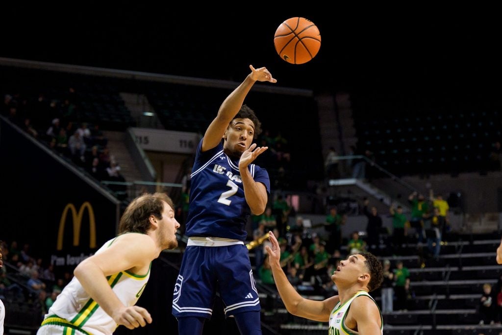 UC Davis guard Marcus Wilson passes the ball as the Oregon Ducks host the UC Davis Aggies on Dec. 13, 2025, at Matthew Knight Arena in Eugene, Oregon.
