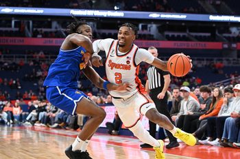 Dec 13, 2025; Syracuse, New York, USA; Syracuse Orange guard JJ Starling (2) drives against Hofstra Pride forward Joshua Decady (4) in the second half at the JMA Wireless Dome. Mandatory Credit: Mark Konezny-Imagn Images