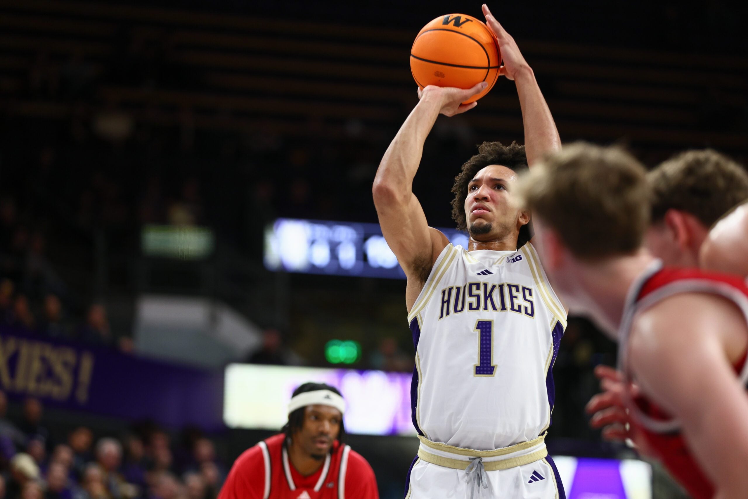 Dec 13, 2025; Seattle, Washington, USA; Washington Huskies guard Desmond Claude (1) shoots a free throw in the first half against the Southern Utah Thunderbirds at Alaska Airlines Arena at Hec Edmundson Pavilion. Mandatory Credit: Kevin Ng-Imagn Images