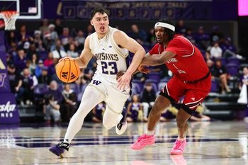 Dec 13, 2025; Seattle, Washington, USA; Washington Huskies guard JJ Mandaquit (23) drives the ball while defended by Southern Utah Thunderbirds guard Elijah Duval (1) in the second half at Alaska Airlines Arena at Hec Edmundson Pavilion. Mandatory Credit: Kevin Ng-Imagn Images