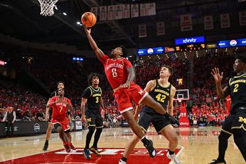 Dec 13, 2025; College Park, Maryland, USA;  Maryland Terrapins guard David Coit (8) attempts a lay up in the second half against the Michigan Wolverines at Xfinity Center. Mandatory Credit: Jamie Sabau-Imagn Images