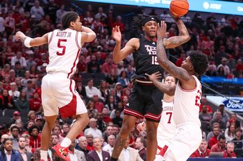 Texas Tech's JT Toppin looks to pass against Arkansas during a non-conference men's basketball game, Saturday, Dec. 13, 2025, in American Airlines Center in Dallas.