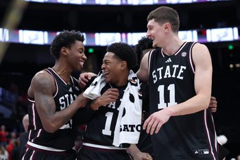 Dec 13, 2025; Salt Lake City, Utah, USA; Mississippi State Bulldogs guard King Grace (23) along with guard Dellquan Warren (1) and forward Sergej MacUra (11) celebrate a win over the Utah Utes after the game at Delta Center. Mandatory Credit: Rob Gray-Imagn Images