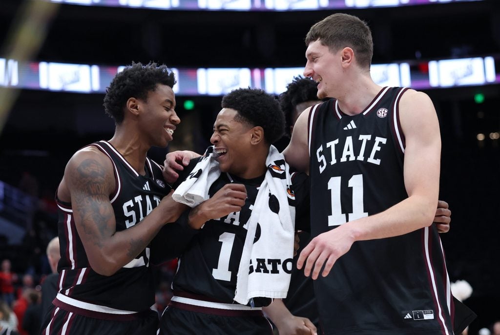 Dec 13, 2025; Salt Lake City, Utah, USA; Mississippi State Bulldogs guard King Grace (23) along with guard Dellquan Warren (1) and forward Sergej MacUra (11) celebrate a win over the Utah Utes after the game at Delta Center. Mandatory Credit: Rob Gray-Imagn Images